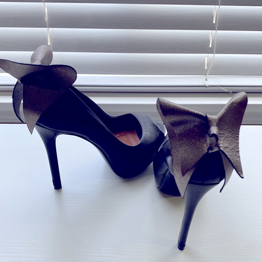 Aldo black platform open toe heel, silver bow on back of the shoe, size 37/7